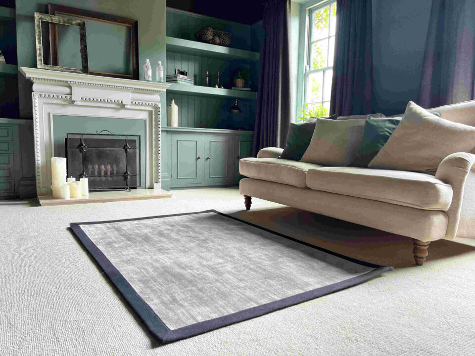 Living Room with sofa & fireplace, featuring Riviera Home's Mayfair carpet in Champagne