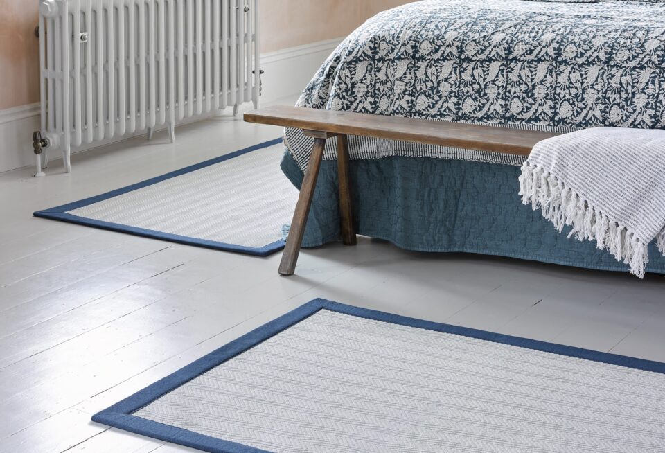Bedroom Room set, showing taped edged rugs around the bed using Riviera Home's Sorrento, Columba.