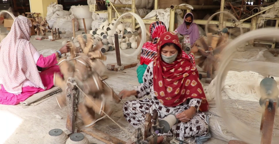Riviera Home Furnishings factory workers winding on hanks of wool.